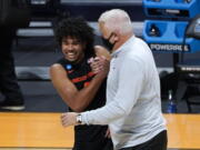 Oregon State guard Ethan Thompson (5) and head coach Wayne Tinkle celebrate beating Oklahoma State 80-70 after a men's college basketball game in the second round of the NCAA tournament at Hinkle Fieldhouse in Indianapolis, Monday, March 22, 2021.