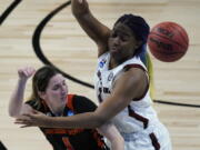 Oregon State guard Aleah Goodman, left, passes around South Carolina forward Aliyah Boston, right, during the second half of a college basketball game in the second round of the women&#039;s NCAA tournament at the Alamodome in San Antonio, Tuesday, March 23, 2021.