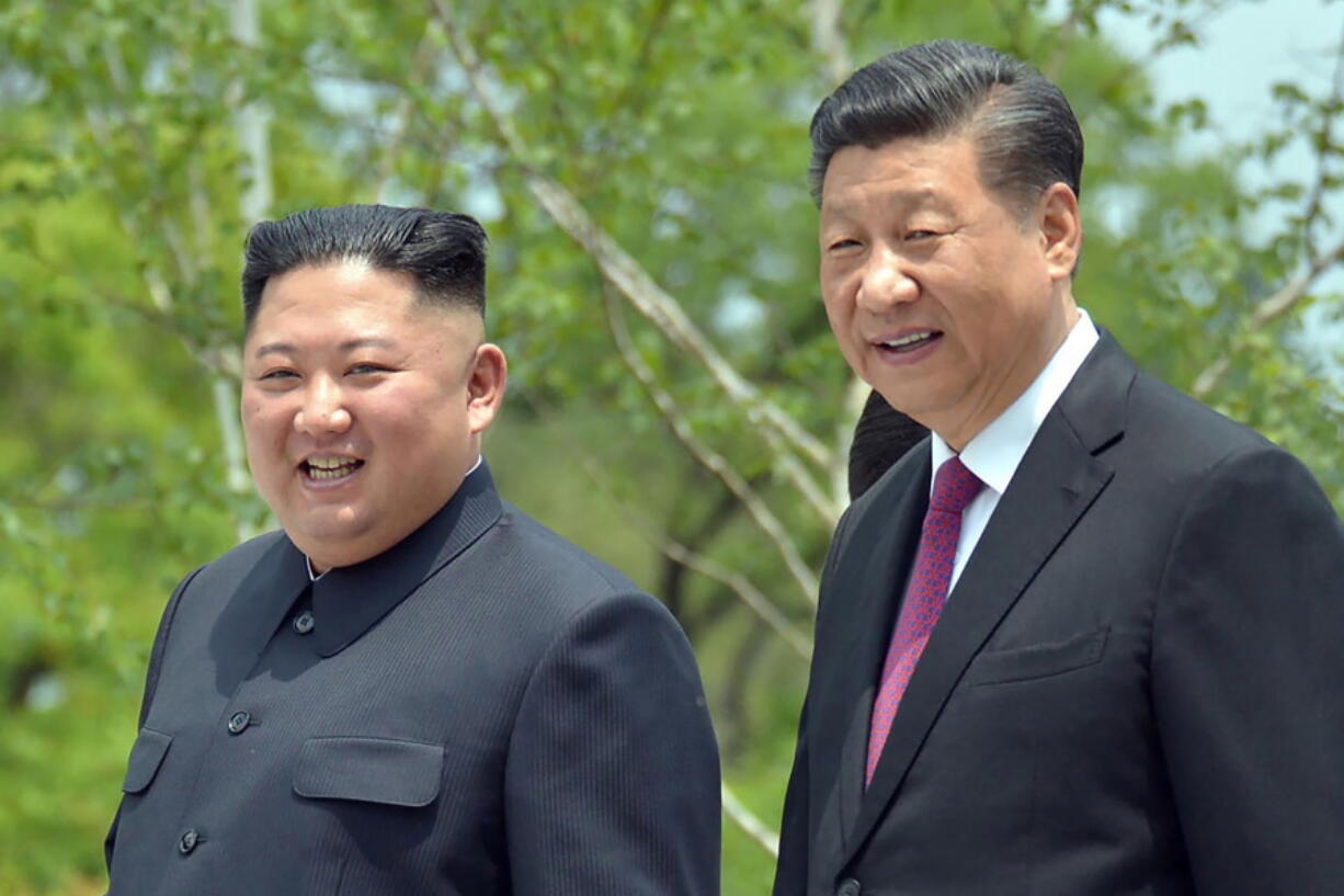 FILE - In this June 21, 2019, file photo provided by the North Korean government, North Korean leader Kim Jong Un, left, and Chinese President Xi Jinping stroll in the premises of Kumsusan guest house in Pyongyang, North Korea. Kim in a message to Xi called for stronger &quot;unity and cooperation&quot; between the countries in the face of challenges posed by &quot;hostile forces,&quot; the North&#039;s state media and Tuesday, March 23, 2021.