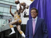 FILE - Elgin Baylor stands next to a statue, just unveiled, honoring the Minneapolis and Los Angeles Lakers great, outside Staples Center in Los Angeles, in this Friday, April 6, 2018, file photo. Elgin Baylor, the Lakers&#039; 11-time NBA All-Star, died Monday, March 22, 2021, of natural causes. He was 86. The Lakers announced that Baylor died in Los Angeles with his wife, Elaine, and daughter Krystal by his side.