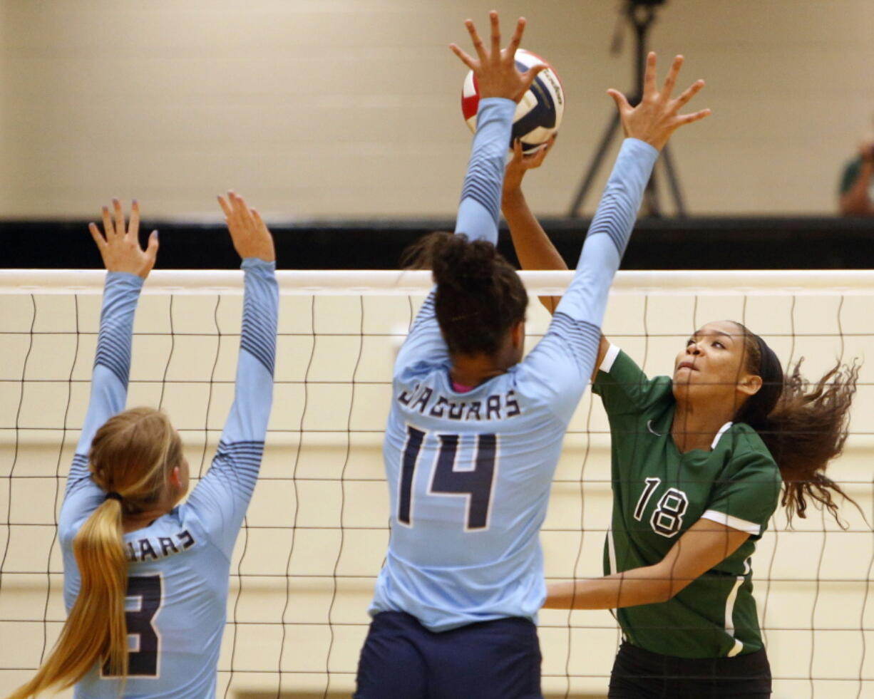 FILE - Reagan&#039;s Kyla Waiters, right, spikes the ball past Johnson defenders during a Texas District 26-6A high school volleyball match in San Antonio, Texas, in this Friday, Sept. 22, 2017, file photo. Oregon State leaders are suing to block disclosure of details about an investigation of abuse allegations in their volleyball program, even as they tout a refreshed mission for transparency in wake of their president&#039;s resignation over the handling of sexual-misconduct cases at another school. &quot;I&#039;m guessing there&#039;s something in those records that they don&#039;t want out,&quot; said Dorina Waiters, whose daughter, Kyla, left Oregon State after a year on the volleyball team triggered depression that led to suicidal thoughts.