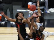 Oregon State&#039;s Ethan Thompson, clockwise from top left, UCLA&#039;s Jules Bernard, Oregon State&#039;s Rodrigue Andela, and UCLA&#039;s Cody Riley (2) vie for a rebound during the second half of an NCAA college basketball game in the quarterfinal round of the Pac-12 men&#039;s tournament Thursday, March 11, 2021, in Las Vegas.