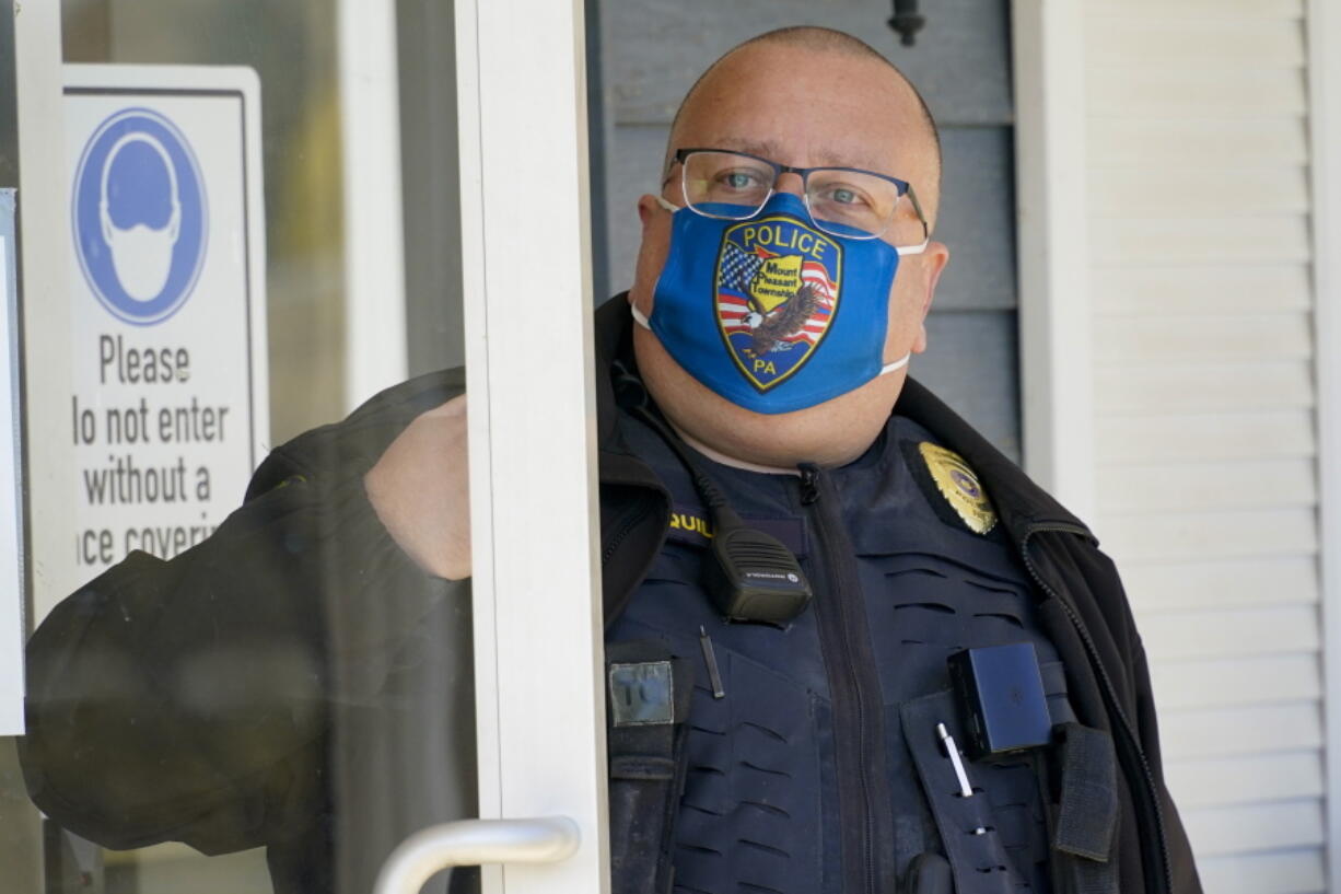 Mount Pleasant Township Police Chief Lou McQuillan answers the door at the municipal building in Hickory, Pa., on Monday, March 15, 2021. McQuillan, who recently announced he is running for a vacant magisterial district judge post, was listed as one of four administrators of a private Facebook group called the Pittsburgh Area Police Breakroom.