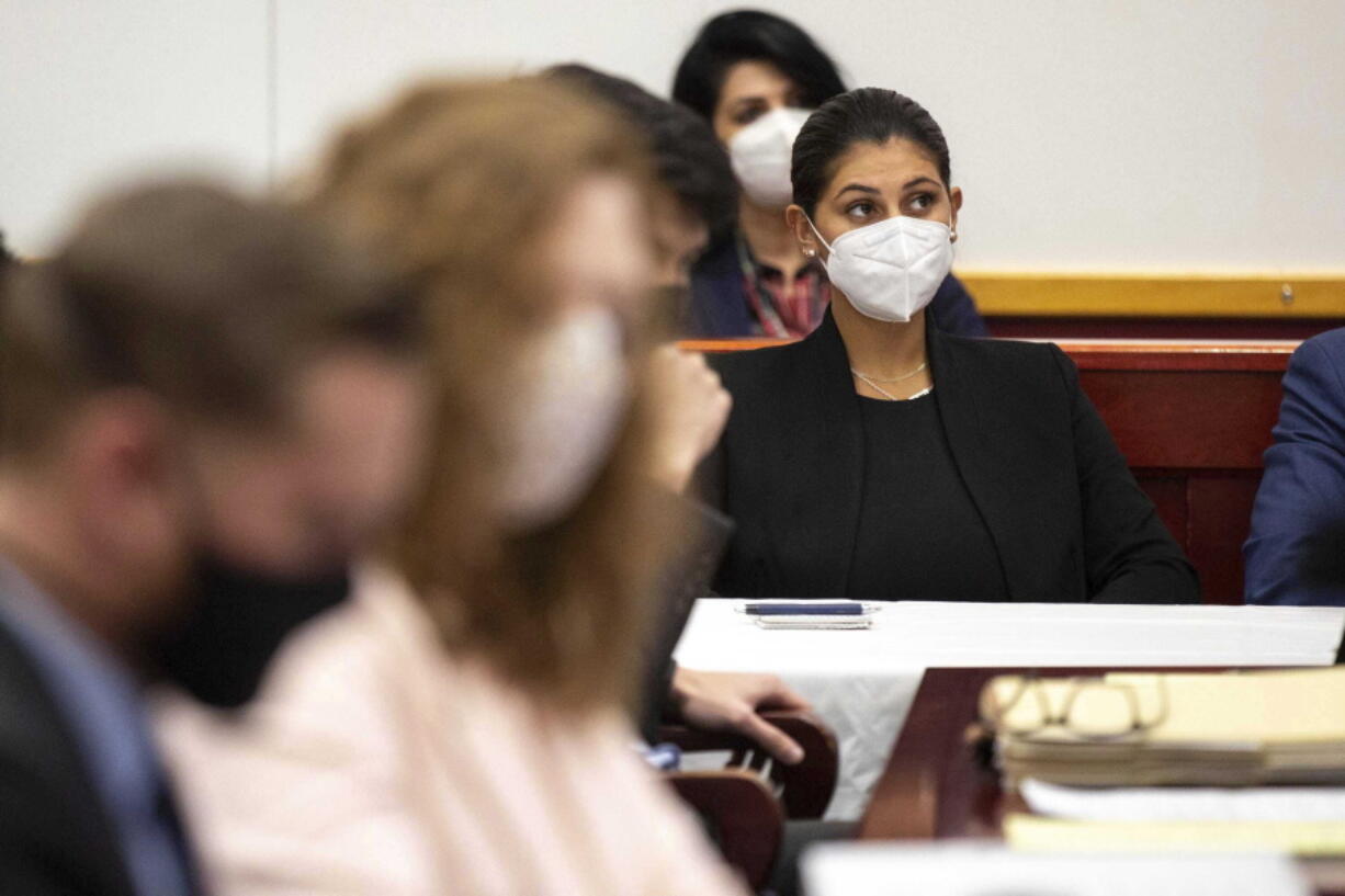 Des Moines Register reporter Andrea Sahouri listens to opening statements in her trial in which she is charged with failure to disperse and interference with official acts while reporting on a protest last summer, Monday, March 8, 2021, at the Drake University Legal Clinic, in Des Moines, Iowa.