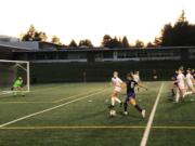 Columbia River forward Maree Seibel advances toward the goal while Cameron Jones of Ridgefield defends during a 2A district playoff game Tuesday at Columbia River High School.