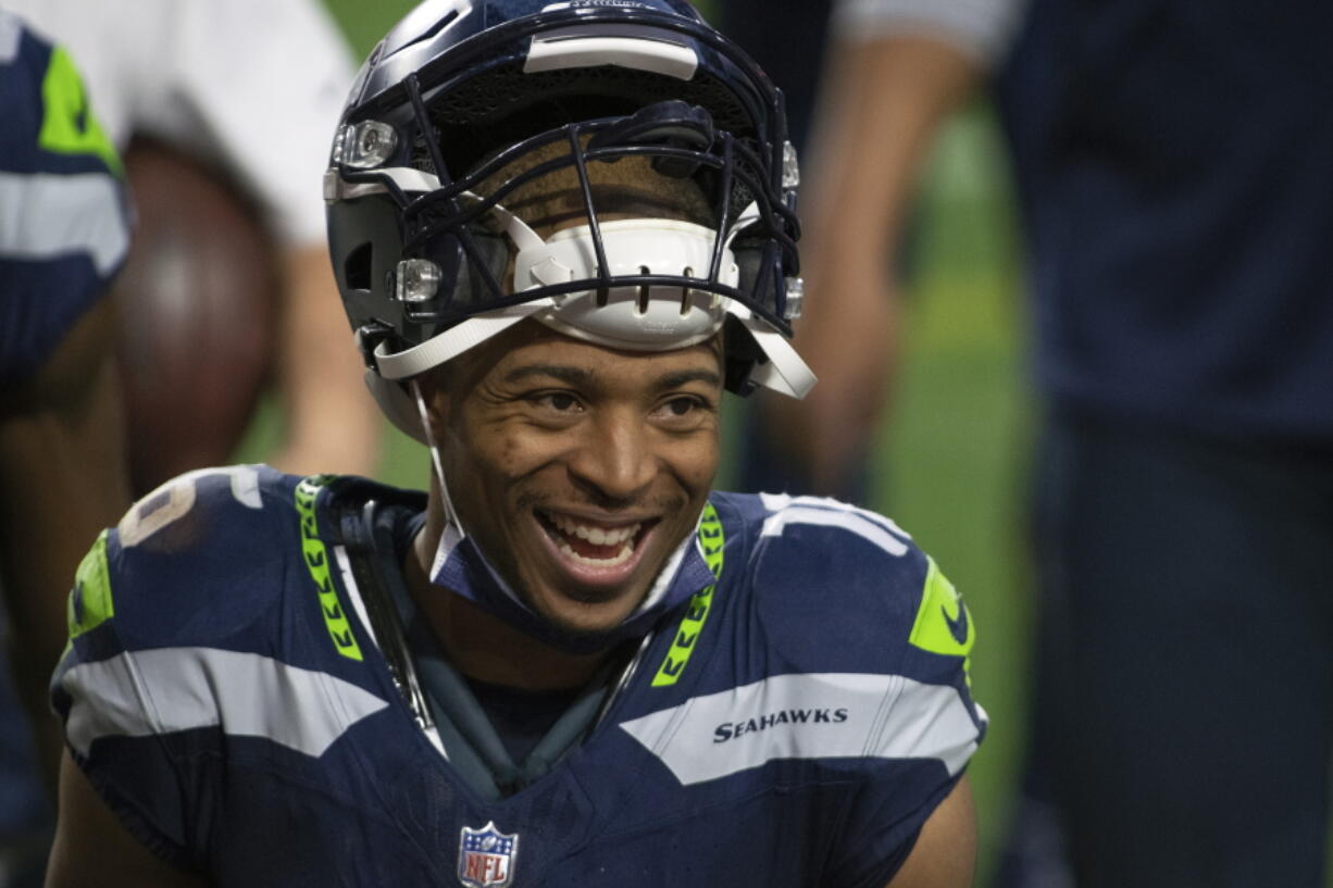 FILE - Seattle Seahawks wide receiver Tyler Lockett smiles after an NFL football game against the San Francisco 49ers in Glendale, Ariz., in this Sunday, Jan. 3, 2021, file photo. The Seattle Seahawks and veteran wide receiver Tyler Lockett have agreed to a four-year contract extension that includes $37 million guaranteed, according to a person with knowledge of the deal. The person spoke to The Associated Press on Wednesday, March 31, 2021, on the condition of anonymity because the extension had not been announced by the team.