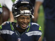 FILE - Seattle Seahawks wide receiver Tyler Lockett smiles after an NFL football game against the San Francisco 49ers in Glendale, Ariz., in this Sunday, Jan. 3, 2021, file photo. The Seattle Seahawks and veteran wide receiver Tyler Lockett have agreed to a four-year contract extension that includes $37 million guaranteed, according to a person with knowledge of the deal. The person spoke to The Associated Press on Wednesday, March 31, 2021, on the condition of anonymity because the extension had not been announced by the team.