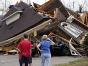 Residents survey damage to homes after a tornado touched down south of Birmingham, Ala. in the Eagle Point community damaging multiple homes, Thursday, March 25, 2021. Authorities reported major tornado damage Thursday south of Birmingham as strong storms moved through the state. The governor issued an emergency declaration as meteorologists warned that more twisters were likely on their way.