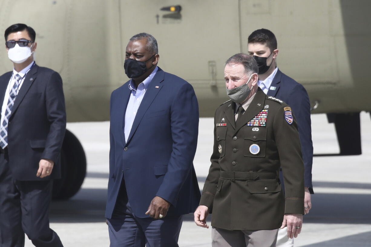 U.S. Secretary of Defense Lloyd Austin, center left, walks with United States Forces Korea, Gen. Robert B. Abrams, after Austin arrived at Osan Air Base in Pyeongtaek, South Korea Wednesday, March 17, 2021.  Austin, with U.S.