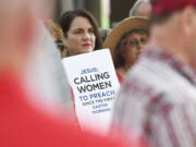 Janene Cates Putman of Athens, Tenn., holds a sign June 11, 2019 during a demonstration outside the Southern Baptist Convention&#039;s annual meeting in Birmingham, Ala.