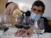 Philippe Darriet, president of the Institute for Wine and Vine Research and head oenologist fills glasses with wine for a blind tasting March 1 at the ISVV Institute in Villenave-d&#039;Ornon, southwestern France.