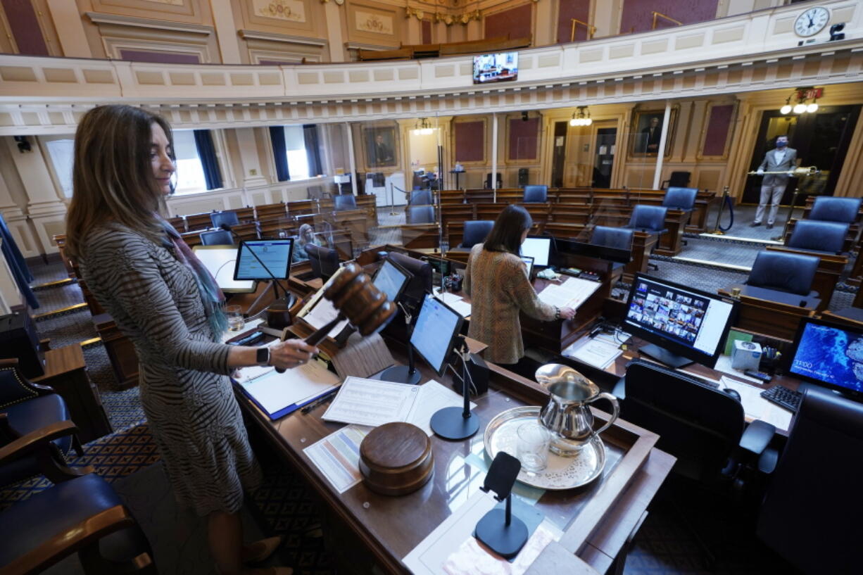 ADVANCE FOR RELEASE MARCH 14, 2021, AND THEREAFTER - FILE - In this Feb. 10, 2021, file photo, House speaker Del. Eileen Filler-Corn, D-Fairfax, gavels in the session to an empty Virginia House of Delegates chamber after a Zoom Legislative session at the Capitol in Richmond, Va. A year after COVID-19 triggered government shutdowns and crowd limitations, more public bodies than ever are livestreaming their meetings for anyone to watch from a computer, television or smartphone. But in some cases, it&#039;s become harder for people to actually talk with their elected officials.