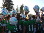 Mountain View players celebrate after the 30-24 overtime win against Prairie on March 12, 2021 (Tim Martinez/The Columbian)