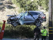 FILE - In this Feb. 23, 2021, file photo, a crane is used to lift a vehicle following a rollover accident involving golfer Tiger Woods, in the Rancho Palos Verdes suburb of Los Angeles. Detectives are looking at data from the so-called &quot;black box&quot; of Tiger Woods&#039; SUV to get a clearer picture of what occurred during the Southern California rollover crash last week that seriously injured the golf star, authorities said Wednesday, March 3. (AP Photo/Ringo H.W.