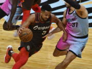 Portland Trail Blazers guard CJ McCollum (3) drives as Miami Heat guard Max Strus (31) defends during the first half of an NBA basketball game Thursday, March 25, 2021, in Miami.