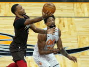 Portland Trail Blazers Norman Powell, left, goes up to shoot past Orlando Magic center Khem Birch during the first half of an NBA basketball game, Friday, March 26, 2021, in Orlando, Fla.