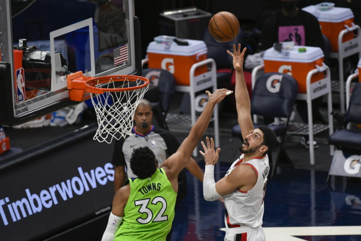 Portland Trail Blazers center Enes Kanter, right, shoots over Minnesota Timberwolves center Karl-Anthony Towns (32) during the first half of an NBA basketball game Saturday, March 13, 2021, in Minneapolis.