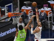 Portland Trail Blazers center Enes Kanter, right, shoots over Minnesota Timberwolves center Karl-Anthony Towns (32) during the first half of an NBA basketball game Saturday, March 13, 2021, in Minneapolis.