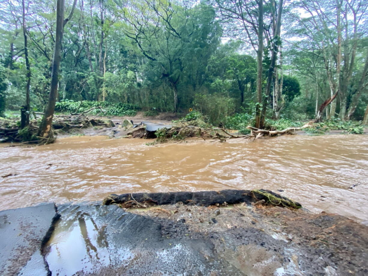 A bridge off Peahi Road is overcome by floodwaters above the Kaupakalua Reservoir and Dam after heavy rainfall on Monday in Haiku, Maui, Hawaii, on Monday, March 8, 2021.