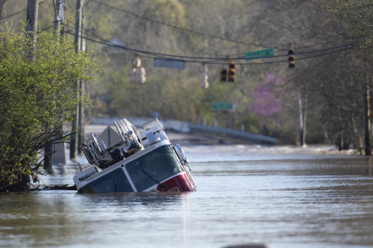 A Nashville Fire Department truck is revealed as flood waters from the Harpeth River recede Monday, March 29, 2021, in Nashville, Tenn. Recent storms dropped seven inches of rain in the area that resulted in flooding and flash flooding across the city.