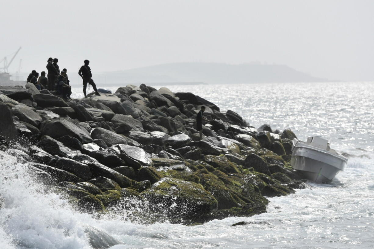 FILE - In this May 3, 2020 file photo, Veneuzuelan security forces guard the shore and a boat in which authorities claim a group of armed men landed in the port city of La Guaira, Venezuela, calling it an armed maritime incursion from neighboring Colombia. Yacsy Alvarez, a woman who was charged in Colombia with helping organize the attempted armed invasion to overthrow Venezuela&#039;s socialist government, says Colombian authorities were aware of the plotters&#039; movements and did nothing to stop them and that she&#039;s being made a scapegoat for the sins of others who abandoned the would be rebels.