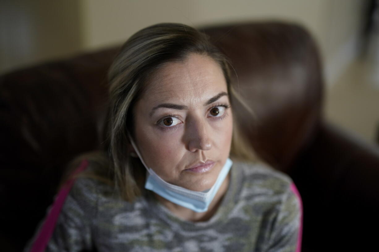 Maura Wozniak poses for a picture on Tuesday, Feb. 23, 2021, in Huntersville, N.C. Wozniak, a 42-year-old mother of 2 has cystic fibrosis and also has undergone lung transplants and has been moved into group 4, just ahead of the general public receive the COVID-19 vaccination.