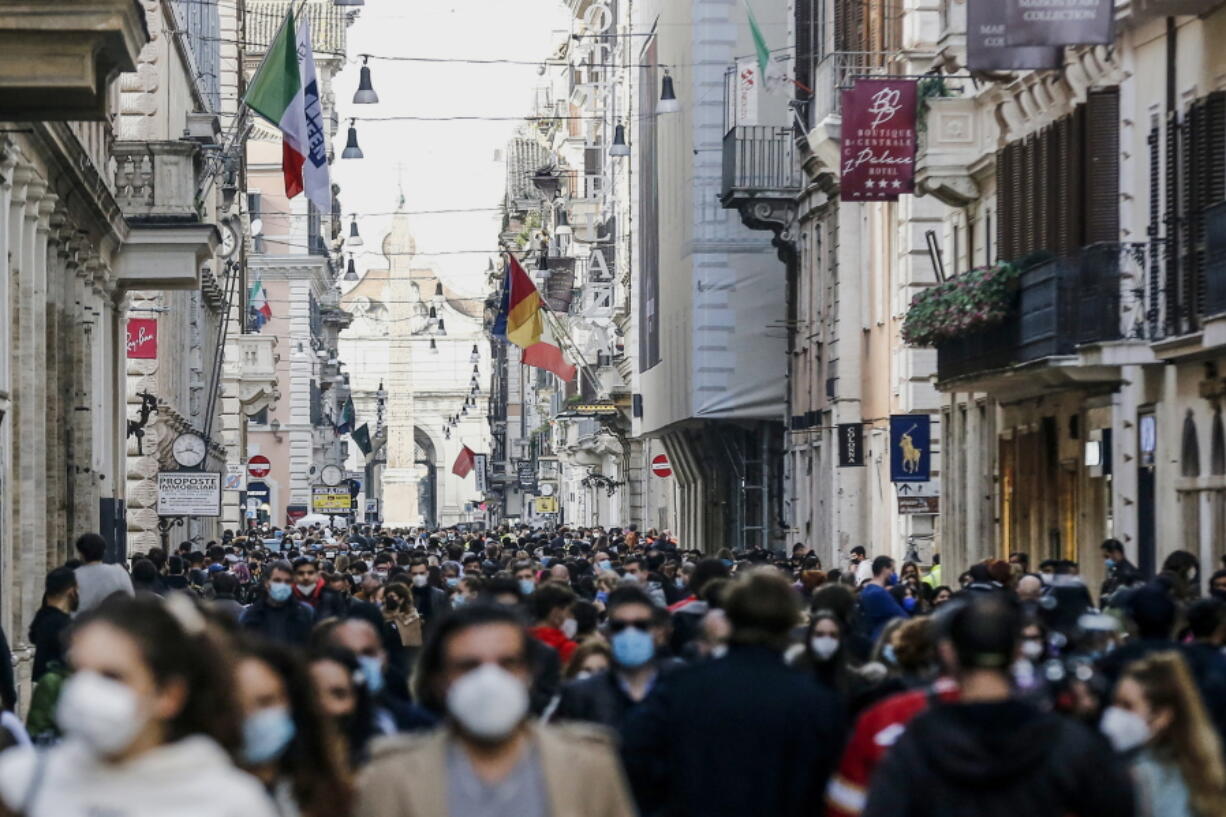 FILE - In this Saturday, Feb. 7, 2021 file photo, people crowd Via del Corso shopping street in Rome, following the ease of restriction measures to curb the spread of COVID-19. Europe recorded 1 million new COVID-19 cases last week, an increase of 9% from the previous week and ending a six-week decline, WHO said Thursday, March 4, 2021. The so-called UK variant is of greatest concern in the 53 countries monitored by WHO in Europe.