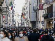 FILE - In this Saturday, Feb. 7, 2021 file photo, people crowd Via del Corso shopping street in Rome, following the ease of restriction measures to curb the spread of COVID-19. Europe recorded 1 million new COVID-19 cases last week, an increase of 9% from the previous week and ending a six-week decline, WHO said Thursday, March 4, 2021. The so-called UK variant is of greatest concern in the 53 countries monitored by WHO in Europe.