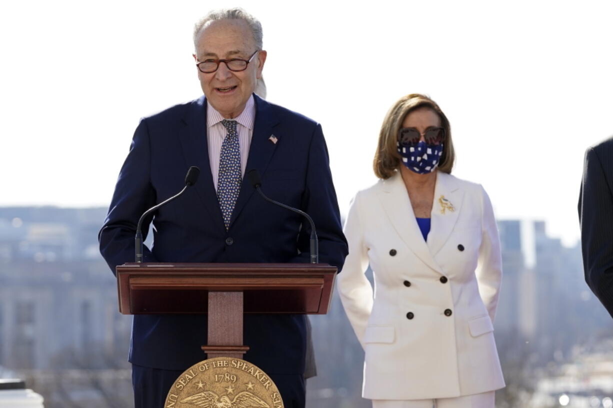 Senate Majority Leader Chuck Schumer of N.Y., speaks as House Speaker Nancy Pelosi of Calif., holds an enrollment ceremony for the $1.9 trillion COVID-19 relief bill, on Capitol Hill, Wednesday, March 10, 2021, in Washington.