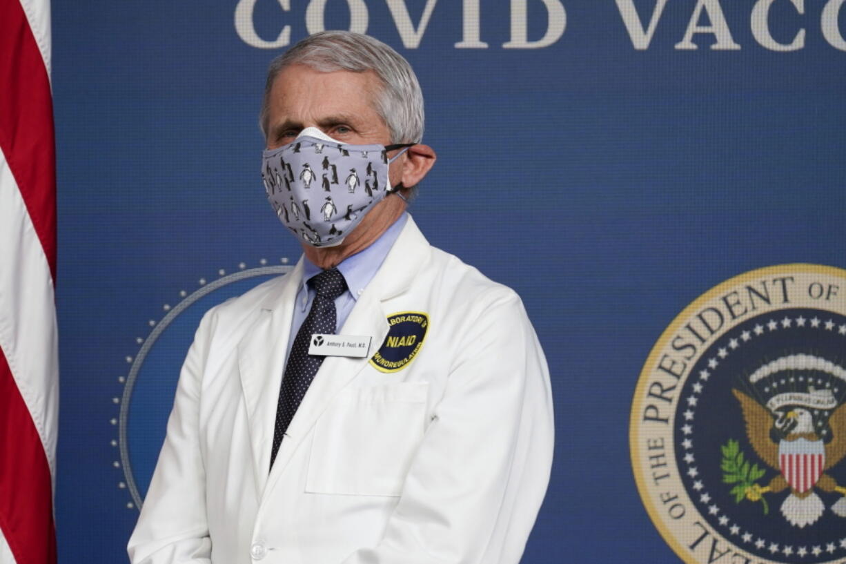 FILE - In this Feb. 25, 2021, Dr. Anthony Fauci, director of the National Institute of Allergy and Infectious Diseases, listens as President Joe Biden speaks during an event to commemorate the 50 millionth COVID-19 shot in Washington.  Fauci said Sunday, March 14,  he wishes former President Donald Trump would use his popularity among Republicans to persuade his followers to get the COVID-19 vaccine. In a round of interviews on the morning news shows, Fauci lamented polling showing that Trump supporters are more likely to refuse to get vaccinated, saying politics needs to be separated from &quot;commonsense, no-brainer&quot; public health measures.