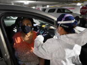 Yvonne Gibbs, 72, receives Moderna&#039;s COVID-19 vaccine, Jan. 27, 2021, at the TCF Center in Detroit. COVID-19 hit Detroit hard. But fast action by city leaders early in the pandemic may have slowed the rampant advance of the virus among Detroit&#039;s largely Black population. Detroit recorded 431 confirmed COVID cases on March 30, 2020, and another 387 two days later, according to the city&#039;s Health Department.