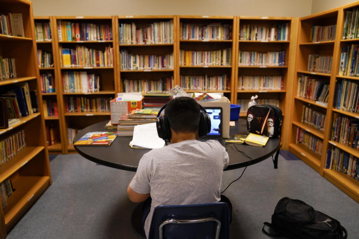 FILE - In this Aug. 26, 2020, file photo, a Los Angeles Unified School District student attends an online class at the Boys &amp; Girls Club of Hollywood in Los Angeles. A new federal survey finds that nearly half of the nation&#039;s elementary schools were open for full-time, in-person instruction last month, but the share of students learning in-person has varied greatly by region and race.  (AP Photo/Jae C.