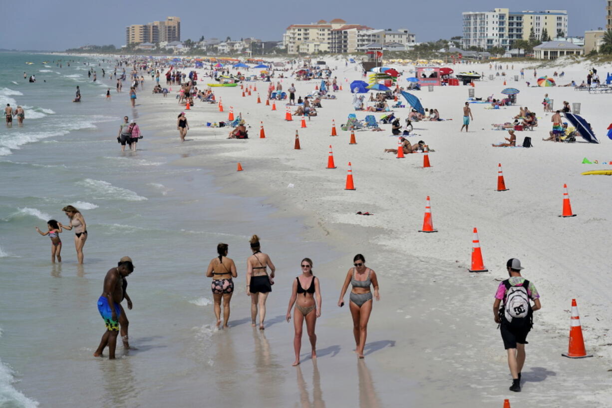 Beachgoers take advantage of the weather as they spend time on Clearwater Beach Tuesday, March 2, 2021, in Clearwater, Fla., a popular spring break destination, west of Tampa. Colleges around the U.S. are scaling back spring break or canceling it entirely to discourage beachfront partying that could raise infection rates back on campus.