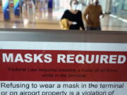 To prevent the spread of Covid-19, a sign directs travelers to wear masks at Love Field Tuesday, March 2, 2021, in Dallas.