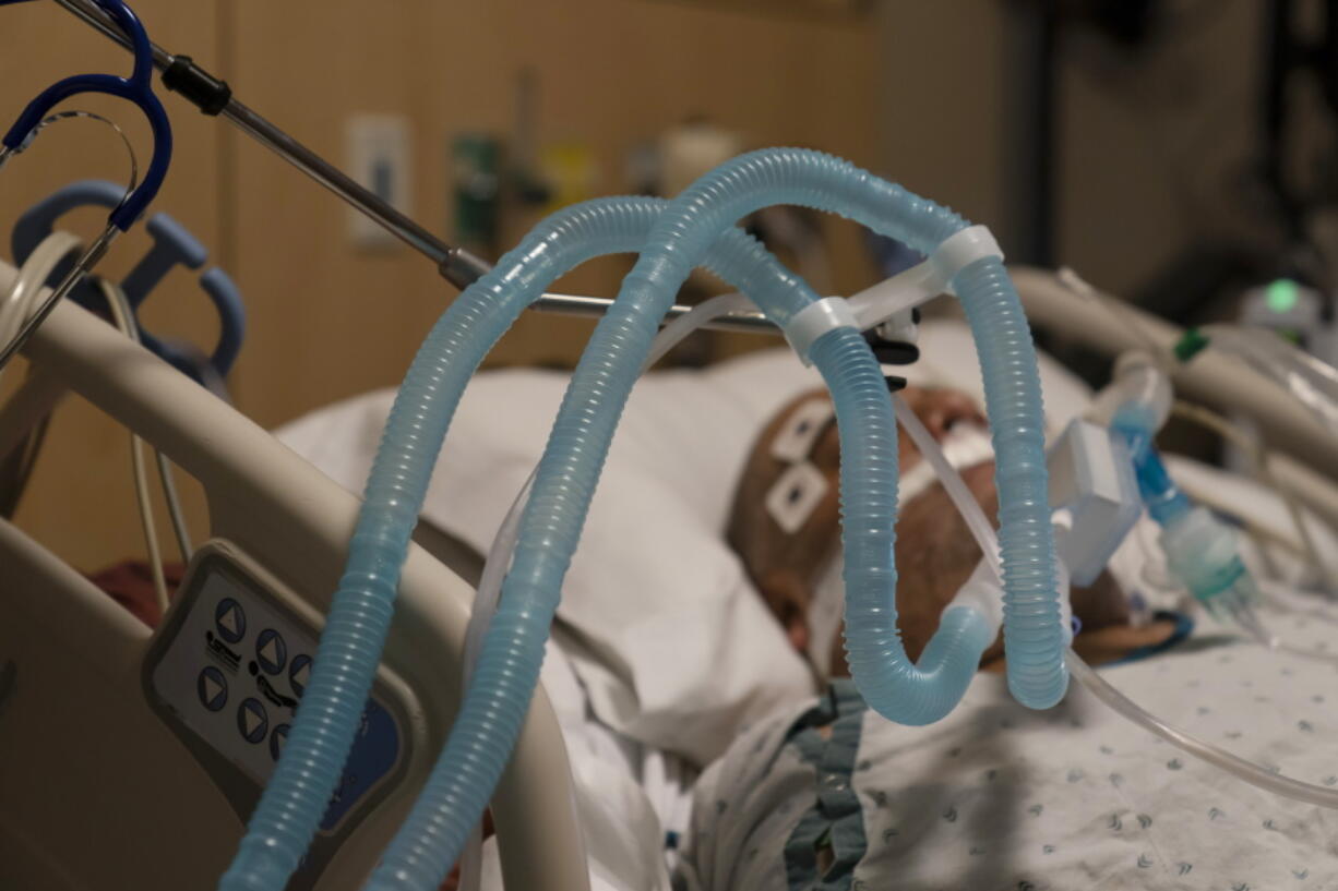 FILE - In this Nov. 19, 2020, file photo, ventilator tubes are attached to a COVID-19 patient at Providence Holy Cross Medical Center in the Mission Hills section of Los Angeles. U.S. deaths from COVID-19 are falling again as the nation recovers from the devastating winter surge. (AP Photo/Jae C.