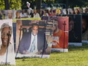 FILE - In this Monday, Aug. 31, 2020 file photo, some of the nearly 900 large poster-sized photos of Detroit victims of COVID-19 are displayed on Belle Isle in Detroit. The COVID-19 pandemic pushed total U.S. deaths last year beyond 3.3 million, the nation&#039;s highest-ever annual death toll, the government reported Wednesday, March 31, 2021.