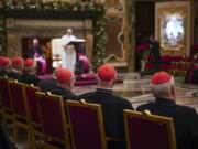 Cardinals listen Dec. 21, 2019, as Pope Francis, background, delivers his Christmas greetings to the Roman Curia, in the Clementine Hall at the Vatican.