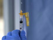 A syringe of the Moderna COVID-19 vaccine is shown Thursday, March 4, 2021, at a drive-up mass vaccination site in Puyallup, Wash., south of Seattle. Officials said they expected to deliver approximately 2500 second doses of the Moderna COVID-19 vaccine at the site Thursday. (AP Photo/Ted S.