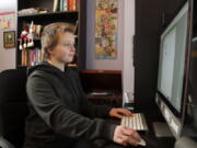 Graciela Leahy, 13, an eighth grader at Ohio&#039;s Columbus Gifted Academy, works on her computer in her bedroom, in Columbus, Ohio, Feb. 23, 2021, to begin a stretch of nearly six straight hours at her desk. A year later in the pandemic, the unplanned experiment with distance learning continues for thousands of students like Leahy who have yet to set foot back in classrooms.