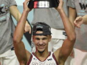 Gonzaga guard Jalen Suggs holds his most outstanding player award with his team after they defeated BYU in an NCAA college basketball game for the West Coast Conference men's tournament championship Tuesday, March 9, 2021, in Las Vegas.