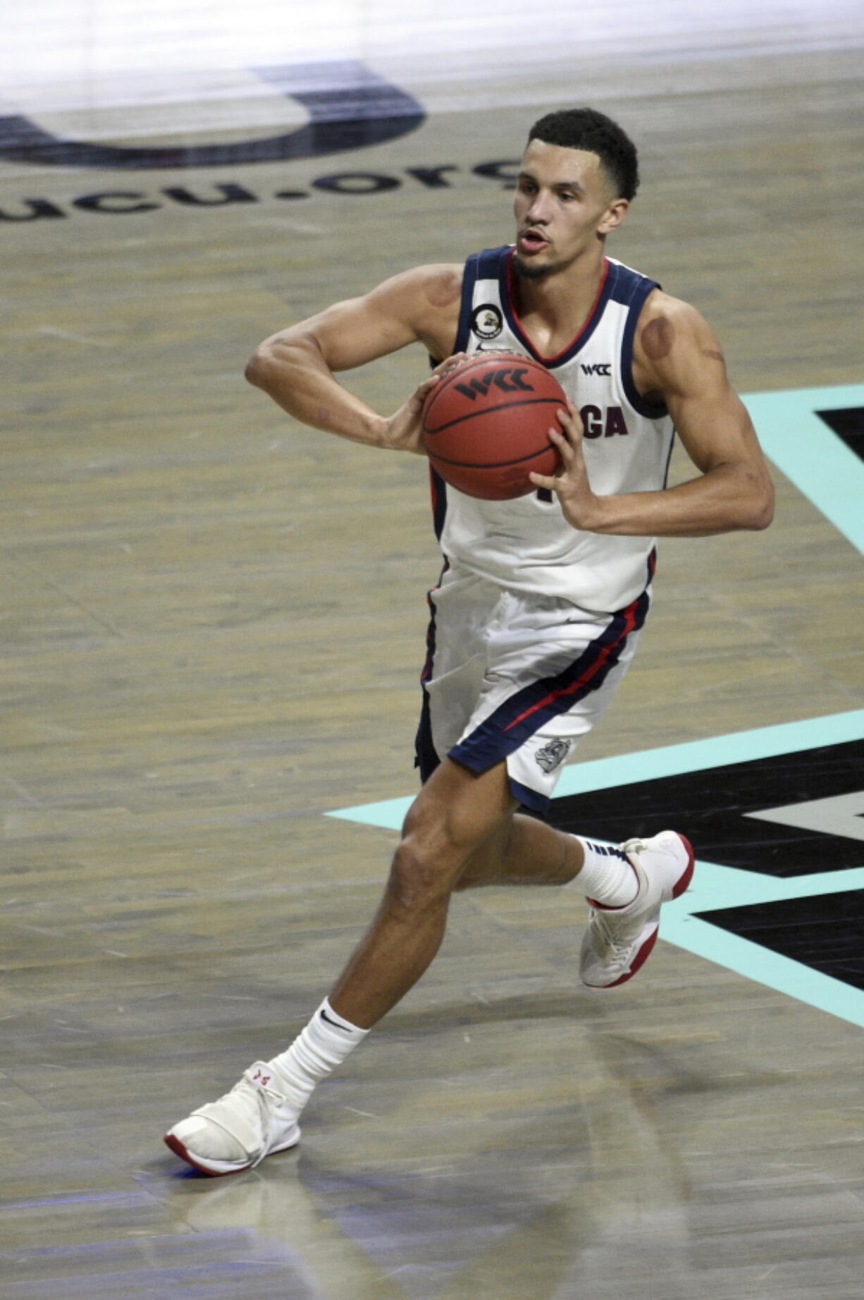 Gonzaga guard Joel Ayayi (11) looks to pass the ball against Saint Mary&#039;s during the first half of an NCAA semifinal college basketball game against Saint Mary&#039;s at the West Coast Conference tournament Monday, March 8, 2021, in Las Vegas.