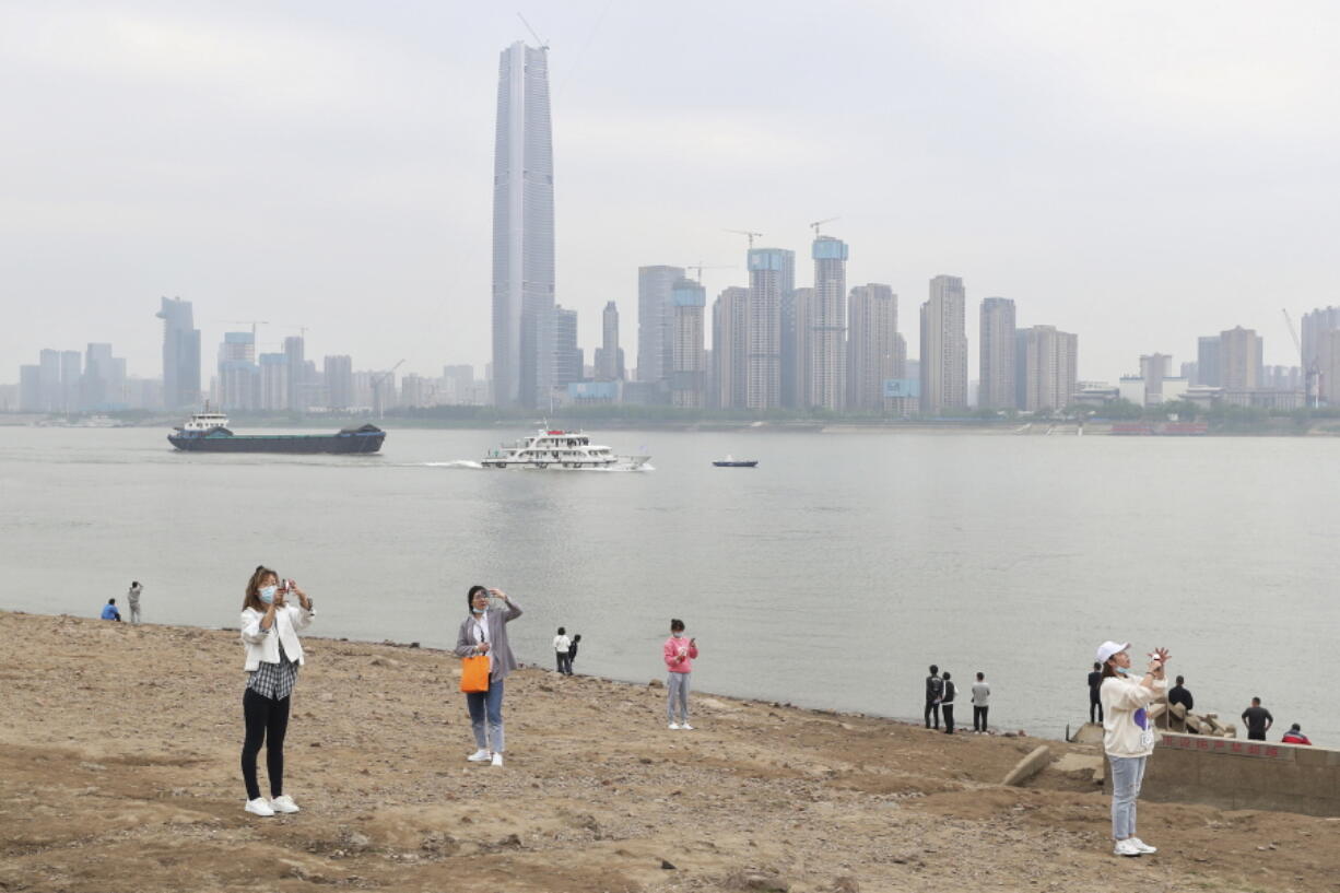 Residents visit the Yangtze River in Wuhan in central China&#039;s Hubei province Monday, March 29, 2021. A joint WHO-China study on the origins of COVID-19 says that transmission of the virus from bats to humans through another animal is the most likely scenario and that a lab leak is &quot;extremely unlikely,&quot; according to a draft copy obtained by The Associated Press.