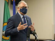 Washington Gov. Jay Inslee speaks Monday, March 22, 2021, at a news conference at Renton City Hall in Renton, Wash., south of Seattle. Inslee and other leaders gathered to denounce recent acts of violence and harassment targeted at Asians and Asian communities. (AP Photo/Ted S.