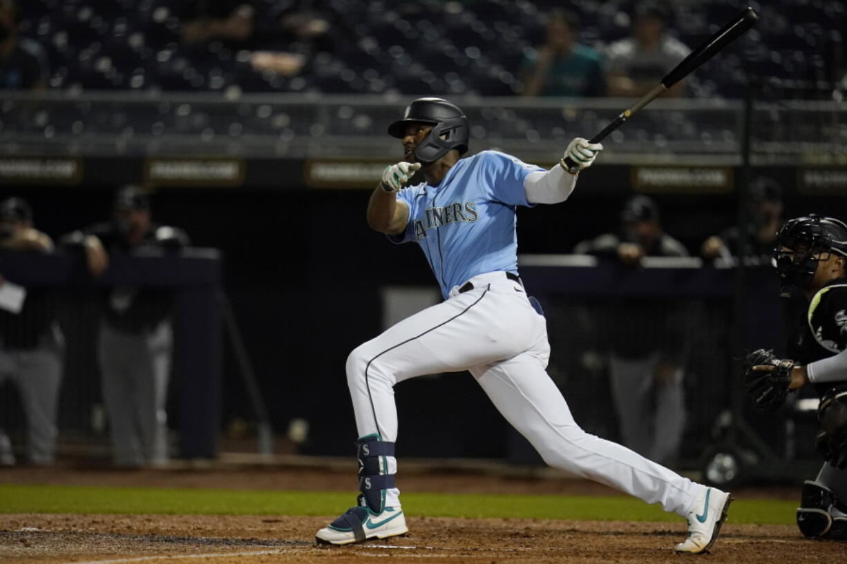 Seattle Mariners&#039; Kyle Lewis watches his home run during the third inning of the team&#039;s spring training baseball game against the Chicago White Sox, Friday, March 19, 2021, in Peoria, Ariz.