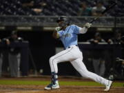 Seattle Mariners&#039; Kyle Lewis watches his home run during the third inning of the team&#039;s spring training baseball game against the Chicago White Sox, Friday, March 19, 2021, in Peoria, Ariz.