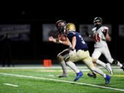 Camas' Jake Blair runs for one of his three touchdowns during Camas' 40-32 win over Kelso (Jordan Nailon/Longview Daily News)