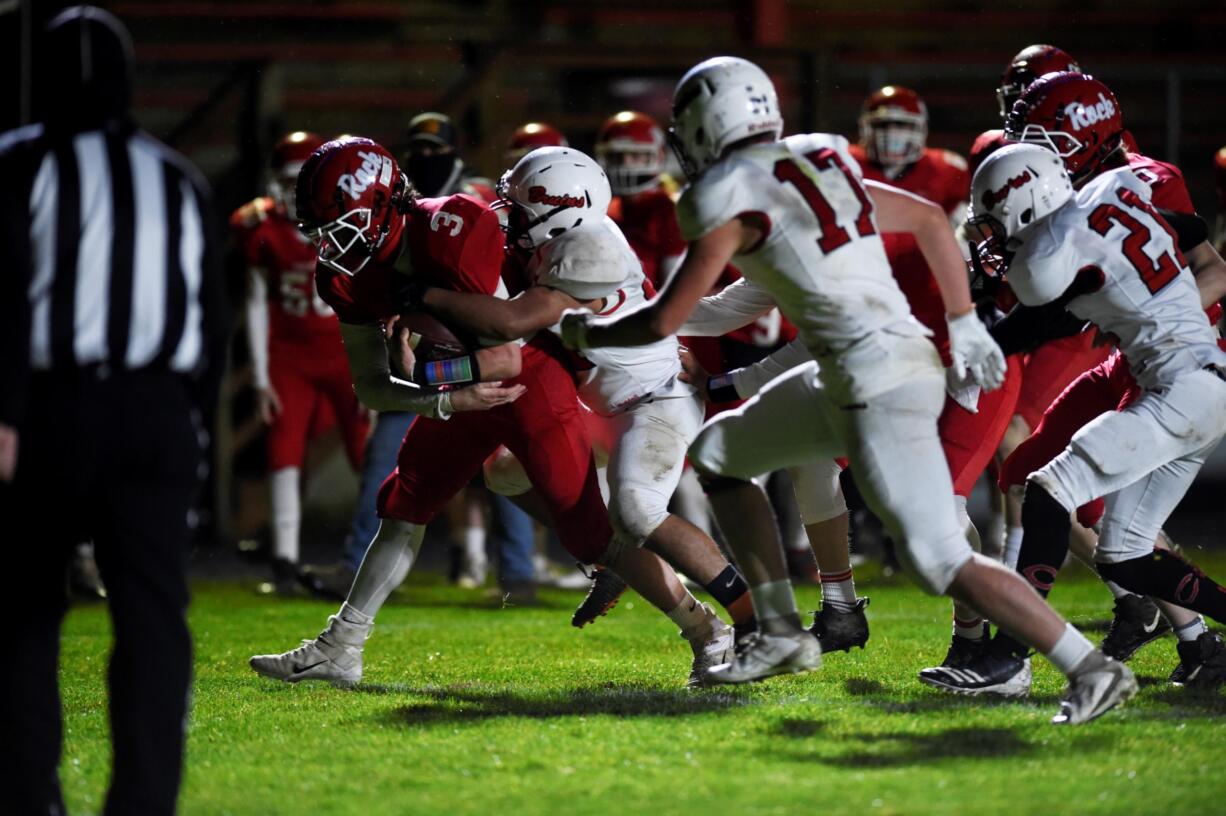 Castle Rock's Austin McQuilliams carries a Columbia-White Salmon defender on Friday (JORDAN NAILON/Longview Daily News)