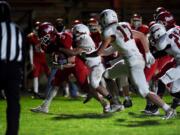 Castle Rock's Austin McQuilliams carries a Columbia-White Salmon defender on Friday (JORDAN NAILON/Longview Daily News)