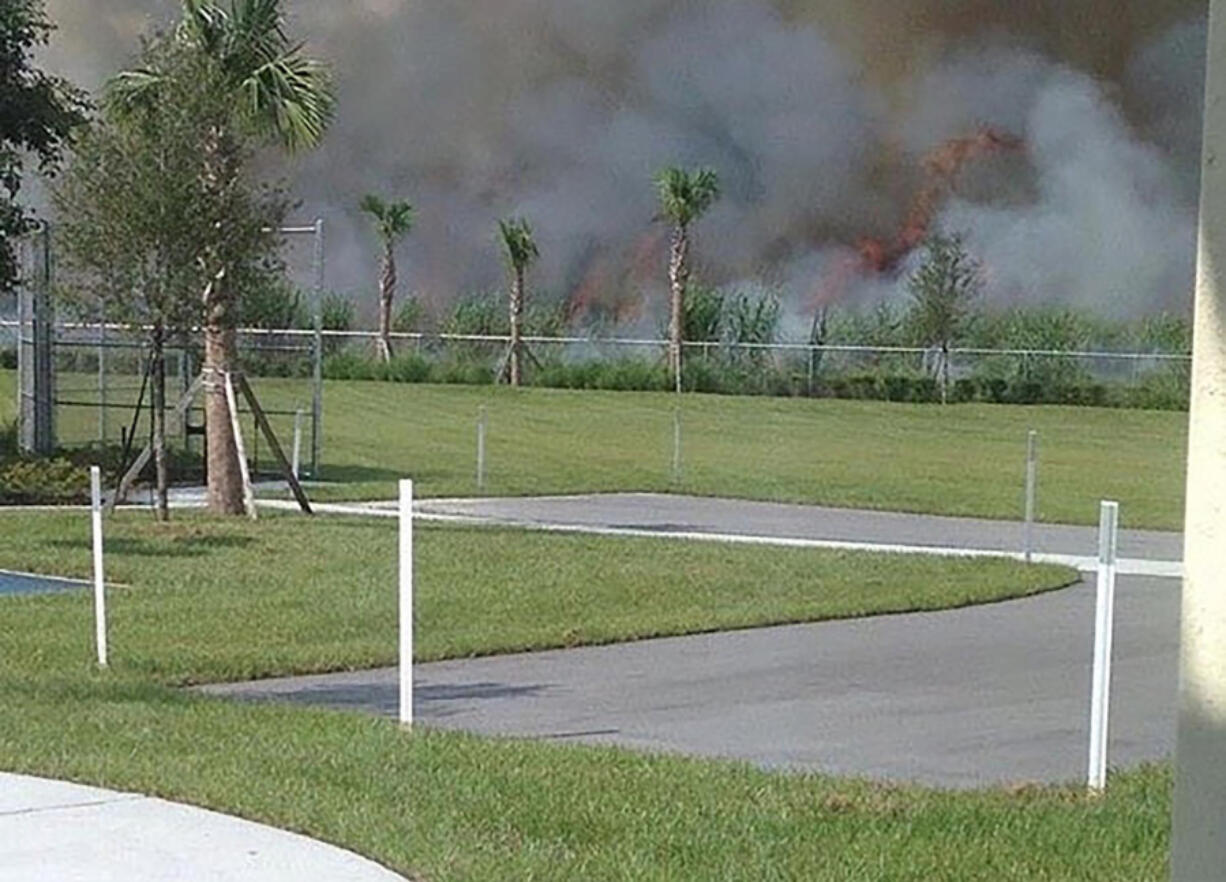 A Rosenwald Elementary School teacher took this undated photo of a sugar cane field burn on a school day just outside the fence surrounding the school grounds in South Bay.