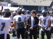 Liam Mallory (in black) walks on the sidelines with his Union teammates in a game against Heritage on March 27.